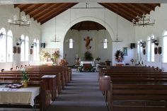 the inside of a church with pews and tables