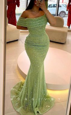 This high-end evening dress features an off-shoulder design, fitted waist and trumpet silhouette, and a showstopping full train. Crafted from luxurious fabrics with a glittery finish, it's the perfect choice for a special event or occasion. Princess And The Frog Prom Dress, Green Prom Dresses Black Women, Glittery Prom Dresses, Cristal Dress, Green Dress Prom, Light Green Prom Dress, Prom Dress Green, Prom Dresses Green, Trumpet Prom Dress