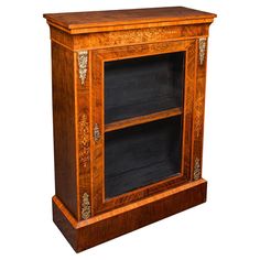 an old fashioned wooden cabinet with black glass doors