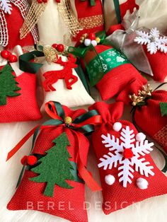 red and green christmas bells with snowflakes on them sitting on a white furnishing