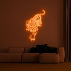 a living room with a couch and a neon tiger wall decal