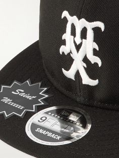 SAINT Mxxxxxx has collaborated with New Era on this baseball cap, a brand that has specialised in the category for about a century. It’s made from twill in the brand's '9FIFTY' profile and embroidered with a mascot on the front. Classic Fitted Hat With Logo Patch For Streetwear, Classic Snapback Hat For Streetwear, Classic Snapback Hat With Logo Patch For Streetwear, Classic Six-panel Fitted Hat For Streetwear, Classic Curved Visor Fitted Hat For Streetwear, Classic Fitted Hat With Curved Visor For Streetwear, Classic Baseball Cap With Embroidered Logo For Streetwear, Black Baseball Cap With Logo And Flat Brim, Classic Streetwear Baseball Cap With Embroidered Logo