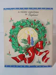 a merry christmas and happy new year card with holly wreath, candle and red ribbon