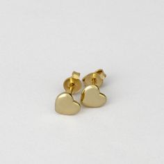 Heart stud earrings, gold heart earrings, 14k gold studs, small gold stud earrings Minimalist Gold Heart Earrings With Charm, Hypoallergenic Gold-plated Heart Earrings In Yellow Gold, Hypoallergenic Yellow Gold Plated Heart Earrings, Minimalist Everyday Heart Earrings, Tarnish Resistant, Gold Minimalist Heart Earrings For Everyday, Minimalist Gold Hypoallergenic Heart Earrings, Dainty Yellow Gold Earrings For Valentine's Day, Dainty Tiny Gold Heart Earrings, Yellow Gold Double Heart Earrings For Everyday