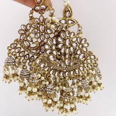 Oversized dull gold Antique finish Bollywood Kundan Earring with sahare /Indian/Punjabi/Pakistani/Statement/Long chandelier/bridal/wedding Length: 4 Inches; Width: 2.5 Inches Arrives in a gift box Color, shades, texture displayed may slightly vary from the actual product due to digital image limitations. We request you to consider these minor variations. Please expect the possibility of some slight imperfections when buying handmade jewelry. If you have any questions, please contact us. Luxury Bollywood Chandbalis For Festive Occasions, Gold Chandelier Earrings With Latkans For Wedding, Gold Chandbalis With Latkans For Wedding, Traditional Gold Bridal Earrings With Stone Work, Gold Chandelier Earrings For Wedding And Festive Occasions, Festive Gold Chandelier Earrings For Wedding, Traditional Wedding Danglers With Pallu Detailing, Traditional Wedding Danglers With Pallu, Stone Work Bridal Earrings For Eid Wedding