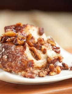 a close up of a plate of food with nuts on it and powdered sugar