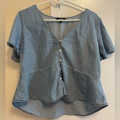 Like New Never Worn Light Blue Shirt With Buttons And Ruffle Short Sleeves. Casual Light Wash V-neck Top, Medium Wash Denim V-neck Top, Trendy Denim V-neck Top, Trendy V-neck Denim Top For Summer, Casual V-neck Blouse, Trendy Light Blue V-neck Blouse, Light Blue V-neck Summer Shirt, Light Wash V-neck Top For Day Out, Casual Medium Wash V-neck Denim Top