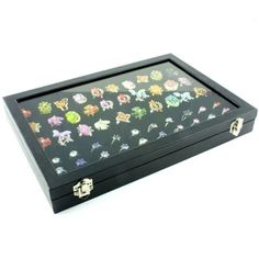 a black box filled with lots of different types of pins on it's lid