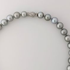 Experience the timeless elegance, crafted with exceptional quality and beauty. The necklace features lustrous Tahitian pearls of various sizes, ranging from 11 to 15 mm, and is finished with an 18K Rhodium-plated white gold and diamond clasp that adds a touch of luxury to the piece. The clasp contains 56 round brilliant cut diamonds (NC/SI) with a total weight of 1.23ct. The pearls showcase a silvery gray color pearls that exudes sophistication and refinement, with a uniformity that creates a harmonious appearance. Each pearl is carefully selected for its exceptional quality and luster, with a high shine and round shape that enhance the necklace's overall elegance. The necklace's length of 18.5 inches makes it versatile, pairing effortlessly with most necklines, and the weight of 112.1 gra Tahitian Pearl Necklace, Pearl Clasp, Tahitian Pearls, Small Jewelry, Pearl Size, Round Brilliant Cut Diamond, Cultured Pearls, Brilliant Cut Diamond, Round Brilliant Cut