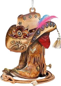 an ornament with a cowboy hat and feather on it's head, hanging from