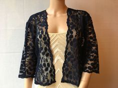 This is a beautiful hand made navy blue lace jacket ideal for weddings or special occasions. The shrug has 3/4 length sleeves. It can also be worn with casual wear. It can be made in any size from 8 to 24 (UK sizes). It is made in the UK. It is normally sent out to you within 5 days, but I am very happy to make your order a priority if you need it urgently. Just let me know the date needed by. Postage is free in the UK! International postage is £9. I am happy to exchange items or refund your pay Elegant Fitted Lace Cardigan, Fitted Lace Cardigan For Party, Elegant 3/4 Sleeve Cardigan For Party, Chic Fitted Lace Cardigan, Elegant Fitted Lace Trim Cardigan, Elegant Fitted Cardigan With Lace Trim, Chic Fitted 3/4 Sleeve Shrug, Fitted 3/4 Sleeve Party Shrug, Elegant 3/4 Sleeve Shrug For Spring