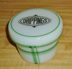 a white and green container sitting on top of a wooden table