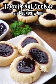 there are cookies with blackberry jam on the plate