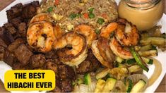 a plate with shrimp, rice and vegetables on it next to a jar of sauce