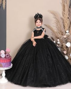 Elevate your little one's presence with our stunning black princess ball gown, perfect for birthdays, pageants, or as a luxurious flower girl dress. Designed for comfort and style, order now to enchant your girl with glamour! ----DETAILS---- > Floor Length > Round Neck with Band Collar > Sleeveless ----ITEM MATERIAL---- Upper layer of the skirt- Glitter Tulle Middle layer of the skirt- Tulle Lower layer of the skirt- Satin Bodice of the dress- Glitter Moonlight, Satin -----COLOR----- If you want Black Princess Style Prom Dress, Princess Style Ball Gown Tutu Dress For Quinceanera, Princess Style Tutu Dress For Quinceanera, Elegant Black Ball Gown For Quinceanera, Black Princess Ball Gown Dress, Princess Evening Ball Gown Pageant Dress, Princess Style Ball Gown Pageant Dress For Evening, Black Princess Style Ball Gown For Party, Princess Style Evening Ball Gown Pageant Dress