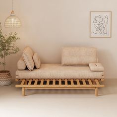 a couch sitting on top of a wooden shelf next to a potted plant