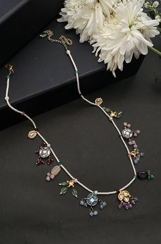 This necklace is a dainty, delightful piece. With a collection of quirky little unit, embellished with colorful stones and pearls, this necklace is perfect piece for the lovers of eccentric designs. Closure - Lobster Style Tip - Meet the perfect amalgam of poetic romance and the surrealism of fairy tales. Reminding us of clear starlit skies, magic and all the poems about love and passion, these designs are perfect for someone who wishes to add poetic details to their selections which are also re White Jeweled Kundan Necklace Gift, Temple Jewelry Style Jeweled Necklace As Gift, Jeweled Temple Jewelry Necklace As Gift, Temple Jewelry Style Necklace As A Gift, White Gemstone Necklace For Party, White Gemstone Party Necklace, Bohemian Jeweled Kundan Necklace For Gift, White Gemstone Temple Jewelry Necklace, White Temple Jewelry Necklace With Gemstone