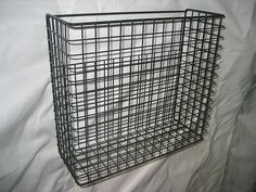 a metal wire basket on a white sheet