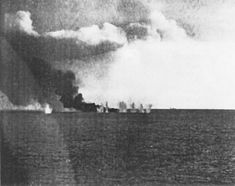 The escort carrier Gambier Bay, burning from earlier gunfire damage, is bracketed by a salvo from a Japanese cruiser (faintly visible in the background, center-right) shortly before sinking during the Battle off Samar. Campaign Pictures, Us Navy Destroyers, Navy Destroyers, Naval Battle, Philippine History, Heavy Cruiser, Imperial Japanese Navy