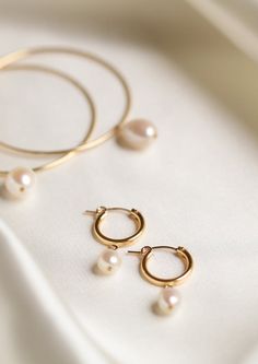 An everyday classic. Polished pearl hoops to give you a classic modern look. • Available in 14k gold filled • Available in 15mm or 18mm hoops • Made in United States Classic Round Pearl Earrings For Everyday, 14k Yellow Gold Filled Round Pearl Earrings, Timeless Round Pearl Earrings For Everyday, Everyday Pearl Charm Huggie Jewelry, Everyday Hoop Jewelry With Pearl Charm, Classic Gold Hoop Earrings With Pearl Charm, Everyday Small Hoop Jewelry With Pearl Charm, Everyday Huggie Jewelry With Pearl Charm, Simple Everyday Jewelry With Pearl Charm