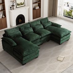 a large green sectional sofa sitting on top of a carpeted floor next to a fireplace