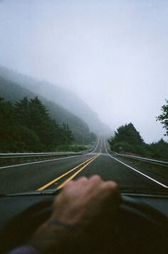 a person driving down the road on a foggy day