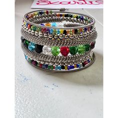 This Wrap Bracelet features colorful beads and an oxidized finish. The unique design allows for versatility in styling, adding a touch of color and texture to any outfit. Crafted with high-quality materials, it is a must-have accessory for any fashion-forward individual. One size fits all. Festival Bracelets With Colorful Metal Beads, Multicolor Metal Beaded Bracelets, Trendy Crystal Bangle Bracelet With Colorful Beads, Trendy Beaded Crystal Bangle Bracelet, Festival Multicolor Metal Beaded Bracelets, Adjustable Multicolor Crystal Bracelet With Silver Beads, Trendy Metal Beaded Bracelets, Multicolor Bohemian Beaded Bracelets With Silver Beads, Multicolor Beaded Chain Bracelet