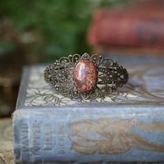 Adjustable dark antiqued brass filigree cuff bracelet with semi-precious stones. Cuff is flexible enough to adjust to any wrist. Choose a Stone: Citrine Quartz, Goldstone, Mahogany Obsidian, Red Jasper, Leopardskin Jasper, or Tigereye Leopardskin Jasper, Mahogany Obsidian, Mechanical Pocket Watch, Brass Filigree, Adjustable Jewelry, Red Jasper, Semi Precious Stones, Wedding Bracelet, Semiprecious Stones