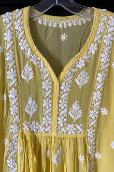 This comfy and beautiful Yellow Gold Lucknowi Hand Embroidered Chikankari Short Frock A-Line Peplum Kurta Pant Set is perfect for any event. Handwork embroidery adorns the front, back, and sleeves, and a Croatia border lace adds a touch of elegance. Included wide-leg pants come with handwork embroidery and a convenient elastic waist band. 2 Piece Muslin Cotton Kurta length 36" inches Sleeves length 18" inches A line Bottom length 39" inches Elastic/drawstring waist Side-seam pockets Croatia bord Embroidered Anarkali Set For Summer, Summer Embroidered Anarkali Set, Embroidered Summer Anarkali Set, Summer Anarkali Set With Floral Embroidery, Cotton Sharara With Resham Embroidery For Summer, Summer Cotton Sharara With Resham Embroidery, Summer Embroidered Anarkali Set In Georgette, Summer Georgette Anarkali Set With Resham Embroidery, Summer Chanderi Dress With Cutdana Detail