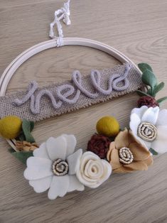 a wooden hoop with flowers and the word ellen on it