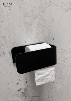 a black and white toilet paper holder on the wall