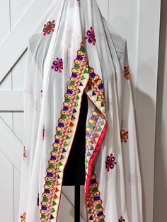 Gorgeous georgette dupatta with mirror and thread work Experience the elegant look and intricate design of our Navaratri Dupatta in white. The perfect combination of georgette fabric with mirror and thread work creates a stunning and luxurious accessory for your traditional outfits. Elevate your style with our high-quality product that adds a touch of sophistication to your Navaratri celebrations. Bohemian Choli With Sheer Dupatta In Chanderi, White Chanderi Embroidered Fabric For Festivals, White Resham Embroidered Fabric For Navratri, White Chanderi Embroidered Fabric In Traditional Drape, White Bollywood Embroidered Fabric For Navratri, White Unstitched Embroidered Fabric For Navratri, Bollywood White Embroidered Fabric For Navratri, Navratri White Unstitched Embroidered Fabric, Bollywood Style White Embroidered Fabric For Navratri