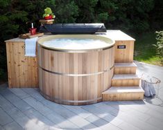 a hot tub sitting on top of a wooden deck