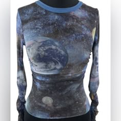 This Women's Urban Outfitters Blue Galaxy Mesh Top Is Perfect For A Night Out On The Town. It Is Made Of A Soft And Stretchy Mesh Fabric That Is Comfortable To Wear. The Top Features A Unique Galaxy Print With Stars, Planets, And Moons. It Has A Slim Fit And Is Cropped At The Waist. The Sleeves Are Long And Have A Ruffled Hem. The Top Is In Excellent Condition And Has Only Been Worn Once. Fitted Blue Y2k Tops, Fitted Blue Y2k Style Tops, Fitted Y2k Blue Tops, Urban Outfitters Blue Graphic Print Tops, Urban Outfitters Blue Tops With Graphic Print, Trendy Fitted Blue Tops, Fitted Crew Neck Crop Top By Urban Outfitters, Urban Outfitters Fitted Crew Neck Crop Top, Trendy Fitted Blue Crop Top