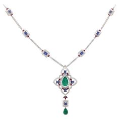 Cast from 18-karat gold, this exquisite necklace is hand set with 6.57 carats Emerald, Blue sapphire and 4.17 carats of sparkling diamonds. FOLLOW MEGHNA JEWELS storefront to view the latest collection & exclusive pieces. Meghna Jewels is proudly rated as a Top Seller on 1stDibs with 5 star customer reviews. All items manufactured by us are handmade and can be customized or redesigned. Certificate of authenticity available upon request. Composition Gross Weight: 23.54 Grams Gold Net Weight: 21.40 Grams Diamond Weight:- 4.17 Carats Diamond Quality: FG--SI Emerald & Blue Sapphire Weight:- 6.57 Carat Necklace Length: 16 Inches Blue Sapphire Pendant, Sapphire Necklace Pendants, Emerald Blue, Blue Sapphire Diamond, Gold Art Deco, Sapphire Pendant, Emerald Necklace, White Gold Necklaces, Diamond Charm