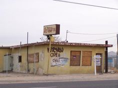 a yellow building with graffiti on the side of it