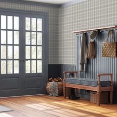 a wooden bench sitting in front of a door next to a basket and coat rack