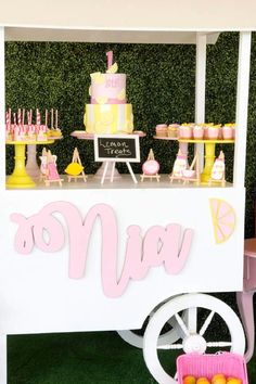 an ice cream cart with pink and yellow decorations