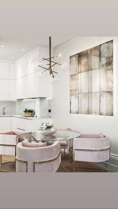 a modern kitchen with white cabinets and pink chairs