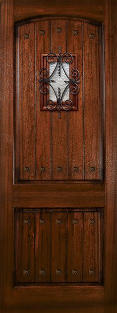 the front door is made from wood and has an intricate metal design on the side