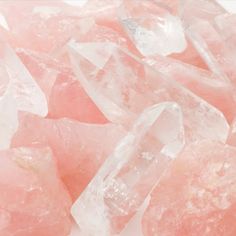 some pink crystals on a white surface