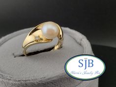 Previously Loved🥰Not New ⚪Vintage Pearl &💎 Ring⚪ A Fabulous Vintage Treasure  Built in all Glowing 14k Yellow Gold ✨️ Featuring a FANTASTIC PEARL STATEMENT Ring Design. Set with a Beautiful Shimmering Cultured Pearl ⚪️ Gemstone center measuring in at approximately 7.4mm with a single prong set Sparkling Genuine/Natural Earth 🌎 Diamonds 💎 weighing in at .03cts. This AMAZING Genuine Pearl and Diamond Ring is PERFECT for your upcoming Wedding or Anniversary STUNNING on its own and a SHOWSTOPPER Luxury Oval Pearl Ring Gift, Pearl Ring Settings, Luxury Yellow Gold Timeless Pearl Ring, Luxury Timeless Yellow Gold Pearl Ring, Luxury Pearl Gemstone Ring For Anniversary, Vintage Pearl Rings, Pearl Ring Design, Pearl Diamond Ring, Pearl Rings Vintage