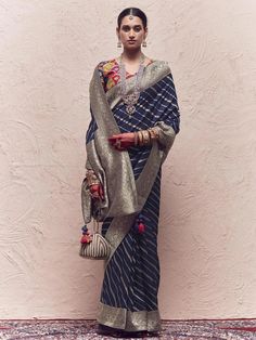 A timeless masterpiece that seamlessly blends traditional craftsmanship with contemporary design, this Navy BLue Woven Banarasi Art Silk Designer Saree is a symbol of elegance and sophistication. Crafted by skilled artisans, each thread tells a story of rich heritage and exquisite artistry. With its intricate motifs and lustrous texture, this saree is a true testament to the beauty of Indian textiles, making it a perfect choice for special occasions and celebrations. This product consists of ready stitched blouse. Designs, colors and patterns on the actual product may slightly vary from designs shown in the image. Images are only representative. Navy Blue Saree Blouse, South Indian Bridesmaids, Saree Navy Blue, Fancy Saree Blouse, Blue Silk Saree, Choli Blouse, Fancy Saree, Bridesmaid Saree, Lehenga Skirt