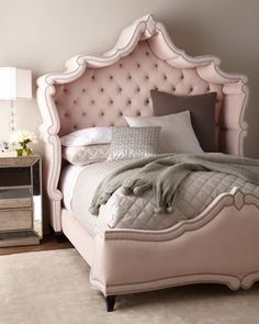 a bedroom with a pink bed and white walls