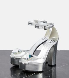 Modern Metallic Sandals With Sculpted Heel, Modern Metallic Heels With Open Heel, Modern Metallic Open Heel Heels, Luxury Metallic Patent Leather Heels, Metallic Leather Open Heel Shoes, Metallic Leather Sandals With Block Heel, Modern Silver Patent Leather Heels, Luxury Metallic Platform Sandals, Metallic Patent Leather Sandals With Open Heel