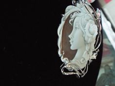 "This is a beautiful modern master hand carved sardonyx cameo by the artist, Carla. This is a very complex and intriguing piece and the design makes it an absolutely amazing piece of work. All the detail is exceptionally done to perfection! The right cameo is cameo is 48 mm mm (1.89\") and it is set into Italian silver with a 6 mm enhancer bail and a pin attachment. It comes packed in a black velvet box and certificate of authenticity for gift giving. Welcome to CASCO Cameos, LLC. CASCO Cameos i Collectible Art Nouveau Carved Jewelry, Carved White Gold Pendant Jewelry, Luxury Cameo Pendant Jewelry, Luxury Cameo Medallion Jewelry, Elegant Cameo Medallion Jewelry, Luxury Carved Pendant Jewelry, Exquisite White Cabochon Jewelry, Luxury Carved Jewelry For Gift, Art Nouveau Oval Cameo Jewelry