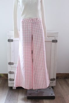 Vintage 70's bell bottom pants.  Pink and white gingham checked.  Wide bells.  Hip huggers.  Button at the waist with a zipper fly.  No pockets. Condition: Good condition.  There is a hole at the bottom of the pants leg, pictured.  A couple tiny spots. Brand: Sears JR Bazaar Fabric: no tag, feels like double knit polyester Measurements: Taken flat, then doubled when necessary. Size: no size tag, probably fits a size medium best Waistband: 33 in. Hips: 44 in. Length: 39 in. Inseam: 31 in. Rise: 1 Chic Gingham Wide Leg Bottoms, Retro Wide Leg Full Length Pants For Spring, Chic Gingham Wide Leg Pants, Retro Plaid Bottoms For Spring, Plaid Cotton Bottoms For Picnic, Chic Gingham Cotton Bottoms, Plaid Wide-leg Pants For Spring, Plaid Straight Leg Pants For Spring, Spring Plaid Wide-leg Pants