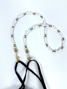 Marshmallow Child Lanyard: Small marshmallow white acrylic beads accented with gold lined glass seed beads and gold metal accents. A sweet incentive to encourage ID, glasses, or mask wear and care and give your child a bit of personality while wearing them. This simple 17 inch child size lanyard keeps hands free and the items off the floor. Mask hooks with simple easy clasps to mask earpieces for use and rests on chest between uses. When you order, let me know if you need eyeglasses or badge holder so I can include them with your lanyard. > Please be aware NOT to use this lanyard if there is a concern for strangling< > Use a flexible measuring tape to make sure the 17 inch length plus mask will be the correct size for your child. Correct size with mask attached, should fit easily overhead Mask Holder, Mask Chain, Glasses Holder, Eye Glass, Gold Line, Metal Accents, Measuring Tape, White Acrylics, Glass Seed Beads