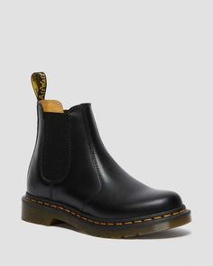 The Original DM's Chelsea boot. The 2976 dates back to the 70s and has a long-running heritage of music and mayhem. Here the classic silhouette returns in our classic Smooth leather, enhanced with yellow welt stitching and a scripted AirWair heel loop. The Chelsea boots sit on a robust air-cushioned sole, as they have since the start. The 2976 is the rugged Docs take on the classic Chelsea boot. Manufactured since the 70s Pull-on style, with elastic gussets Serves up all the signature Doc’s ... 2976 Chelsea Boots, Back To The 70s, Dr Martens 2976, Black Dr Martens, Yellow Heels, Black Chelsea Boots, Leather Chelsea Boots, Goodyear Welt, Chelsea Boot