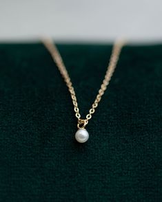 This Mini Pearl Pendant Necklace is the perfect complement for your evening wear or casual wardrobe. Crafted from 14k gold, this delicate necklace features a small cultured pearl, lending it a minimalist and elegant look. With this classic and versatile accessory, you're sure to make a statement. Pearl size: 2.75-3mm 14k Yellow Gold Dainty Yellow Gold Pearl Necklace For Formal Occasions, Classic Pearl Necklace With Delicate Chain, Classic 14k Gold Necklace With Pearl Charm, Minimalist Akoya Pearl Necklace For Formal Occasions, Classic 14k Gold Pearl Necklace With Round Pendant, Simple Formal Jewelry With Delicate Chain, Delicate 14k Gold Pearl Necklace With Pendant, Classic 14k Gold Necklace With Pearl Pendant, Classic 14k Gold Pendant Pearl Necklace